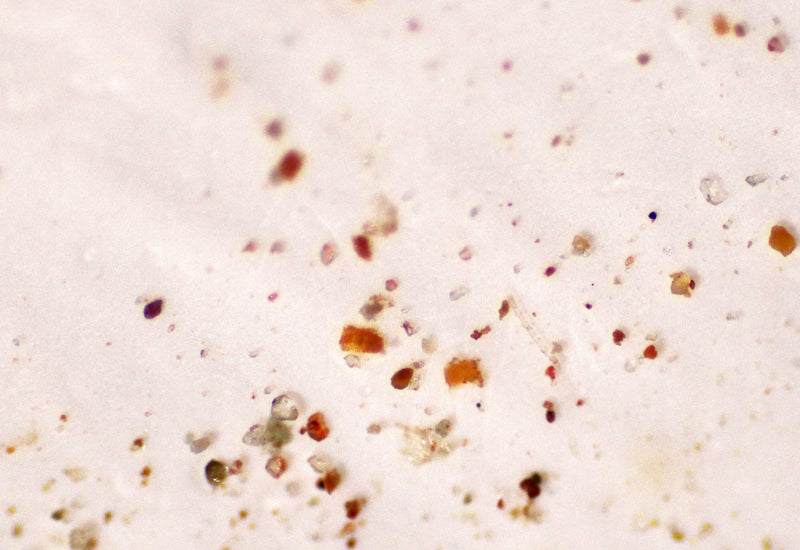 What are microplastic particles and how do they enter the environment?